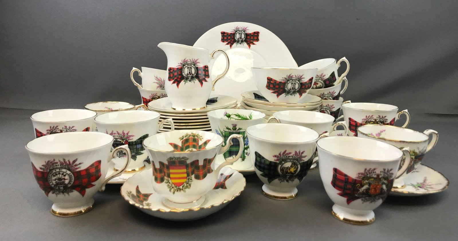 Group of 45+ Pieces : Assorted Scottish Clan Tartan: Largest is 9 3/4 inches-2 handle plate. Smallest tea cup measures 4 1/4 x 2 3/4 inches. Clans include Campbell, Cameron, Macleod, Maclean, Royal Stewart, and more. Royal Albert Bone China, Royal Graft
