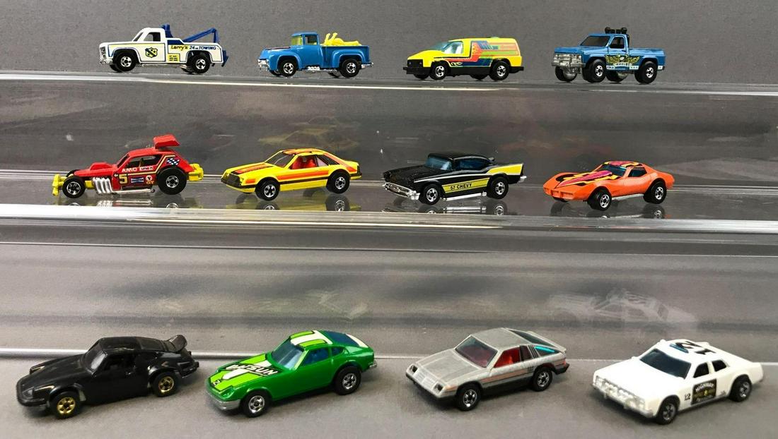 Group of 12 Hot Wheels Die-Cast Vehicles circa: 1976 Z Whiz, 1980 Omni 024, 1975 Corvette Stingray, and more. Includes Hot Wheels Getaway Set carrying case