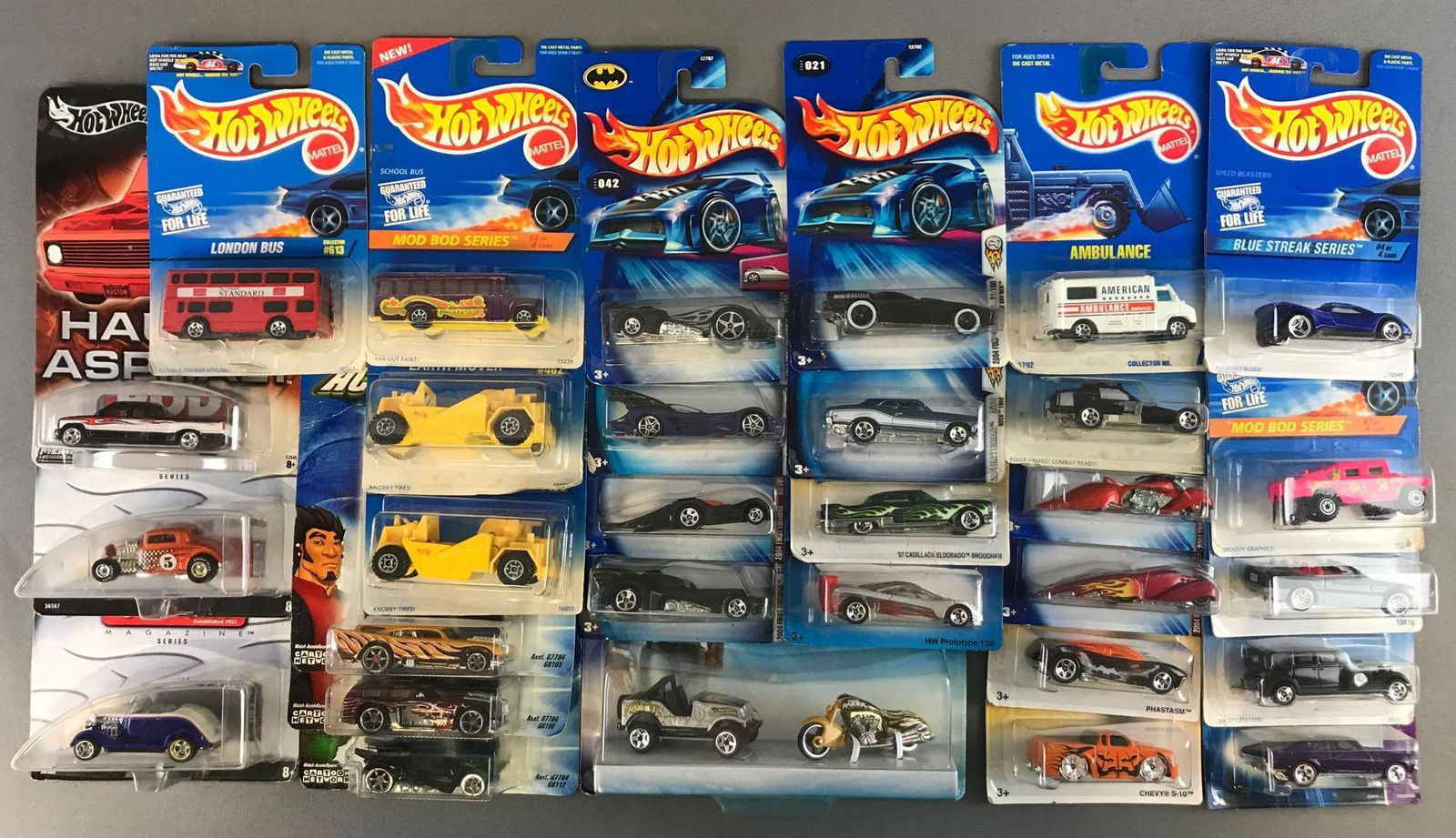 Group of 30 Hot Wheels Die-Cast Vehicles: New in original packaging. 2 piece Tomb Raider set, AcceleRacers, assorted Batmobiles, Mod Rod Series, Rod & Custom Magazine, and more