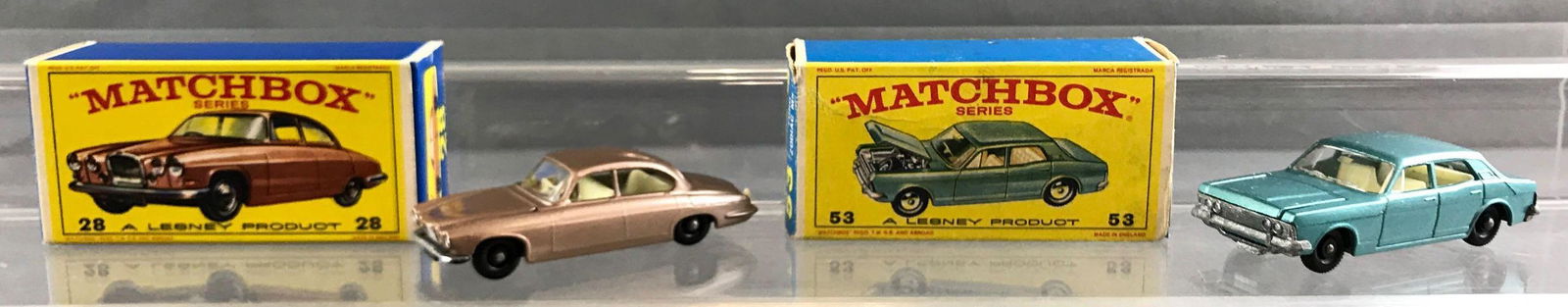 Group of 2 Matchbox die cast vehicles in original boxes: A Lesney Product. Includes no 28 Mark Ten Jaguar, no 52 Ford Zodiac MK IV. Zodiac feels slightly tacky, box has some minor wrinkles and wear.
