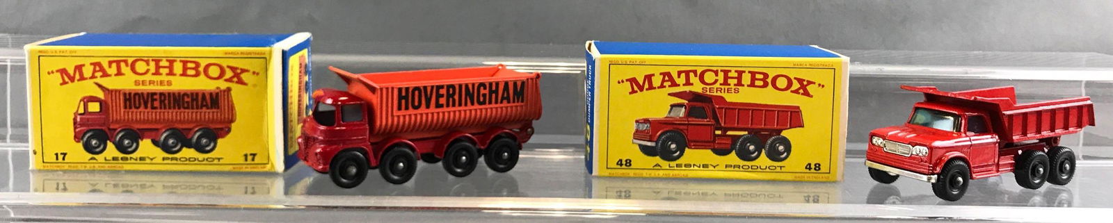 Group of 2 Matchbox die cast vehicles in original boxes: A Lesney Product. Includes no 17 8-wheel tipper, no 48 Dodge dumper truck. Topper truck is slightly crushed on one end.