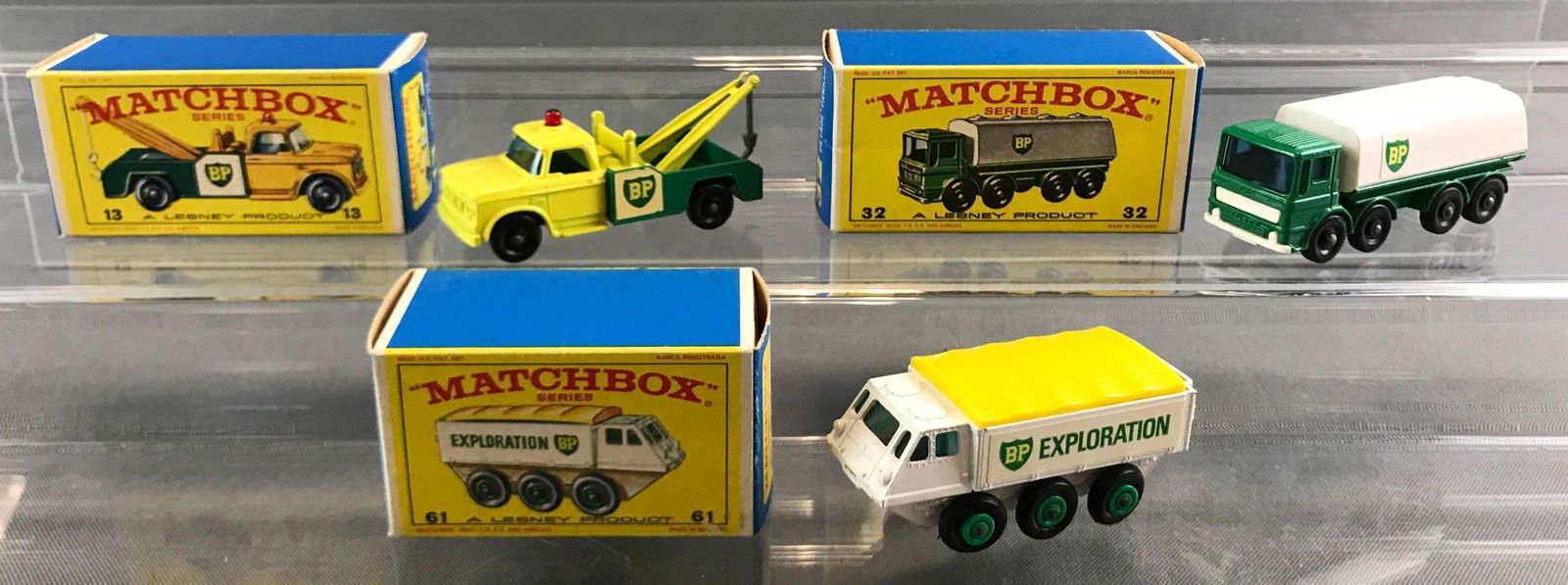 Group of 3 Matchbox die cast vehicles in original boxes: A Lesney Product. Includes no 13 Dodge wreck truck, no 32 Leyland petrol tanker, no 61 Alvis Stalwart.