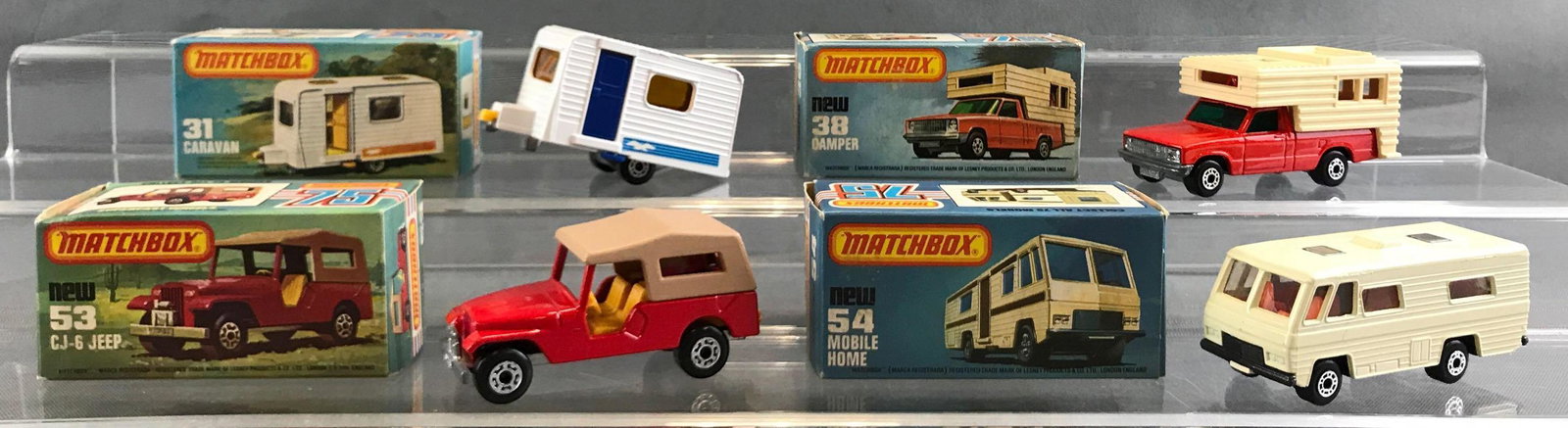 Group of 4 Matchbox die cast vehicles in original boxes: Includes no 31 caravan, no 38 camper, no 53 CJ-6 Jeep, no 54 mobile home.