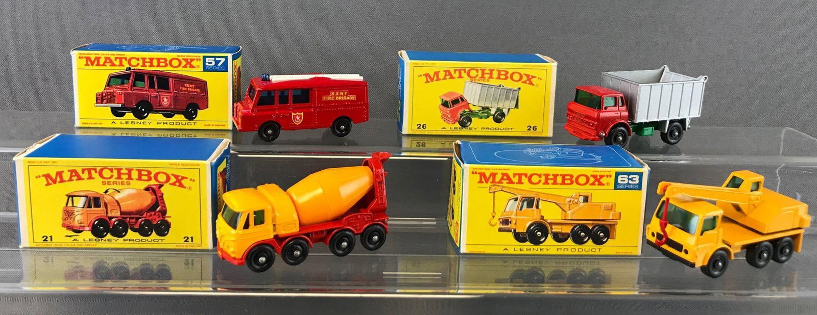 Group of 4 Matchbox Die-Cast Vehicles with Original: Includes No. 21 Foden Concrete Truck, No. 63 Dodge Crane Truck, No. 57 Land Rover Fire Truck, and No. 26 G.M.C. Tipper Truck