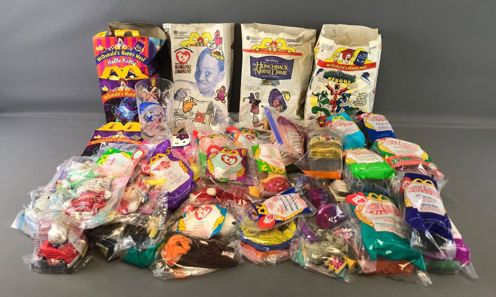 Group of 70+ McDonalds Happy Meal Toys, bags, and boxes: Hello Kitty/Beast Machines, Teenie Beanies, Power Rangers, Hunchback of Notre Dame