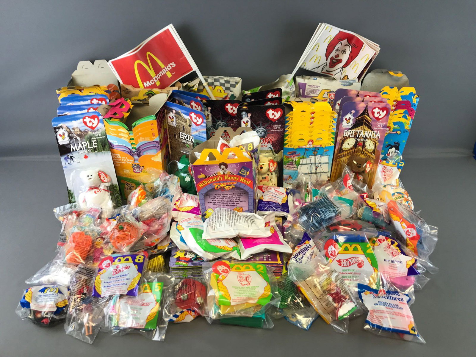 Group of 100+ McDonalds Happy Meal Toys, boxes, bags,: Barbie/Hot Wheels, Monster Crazy Bones, Muppet Treasure Island, and more