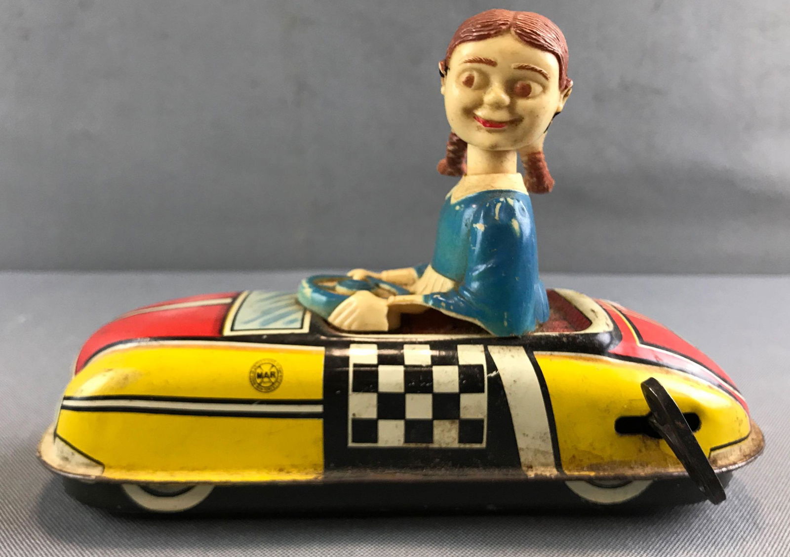 Vintage Marx toys tin wind up race car: Winding mechanism needs repair. Girl is broken. 7 inches long