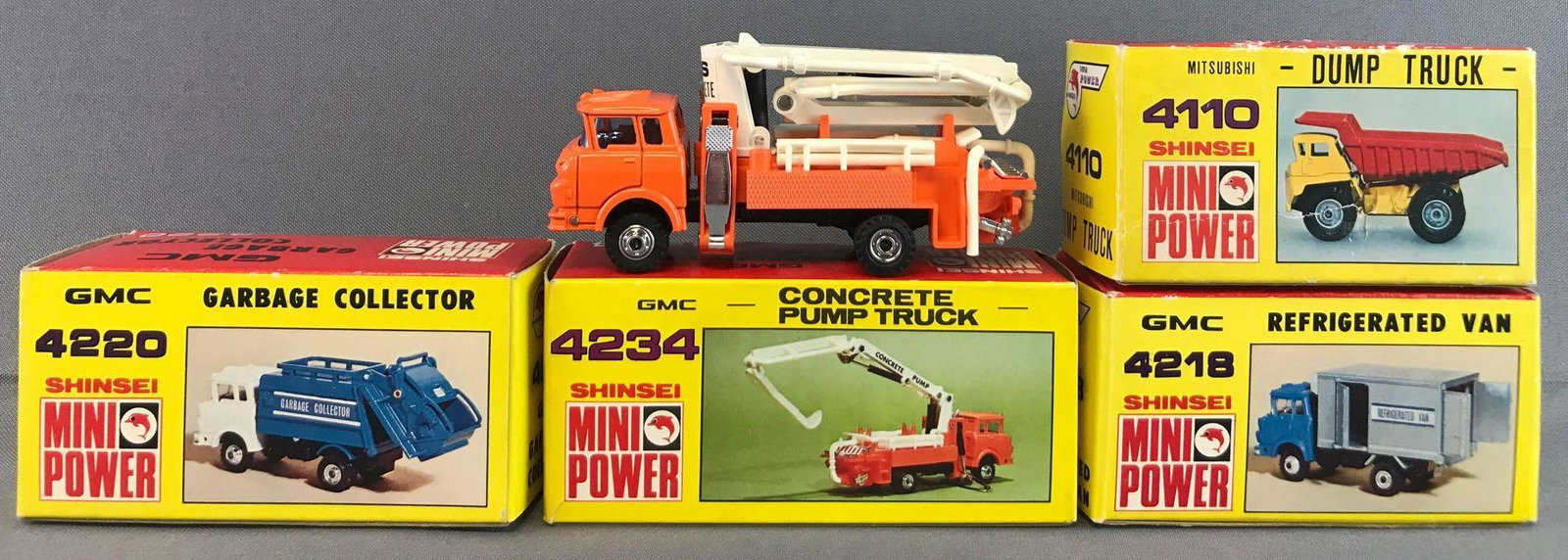Group of 4 Shinsei Mini Power Die-Cast Vehicles in: Includes 4220-GMC Garbage Collector, 4234-GMC Concrete Pump Truck, 4218-GMC Refrigerated Van, and 4110-Mitsubishi Dump Truck