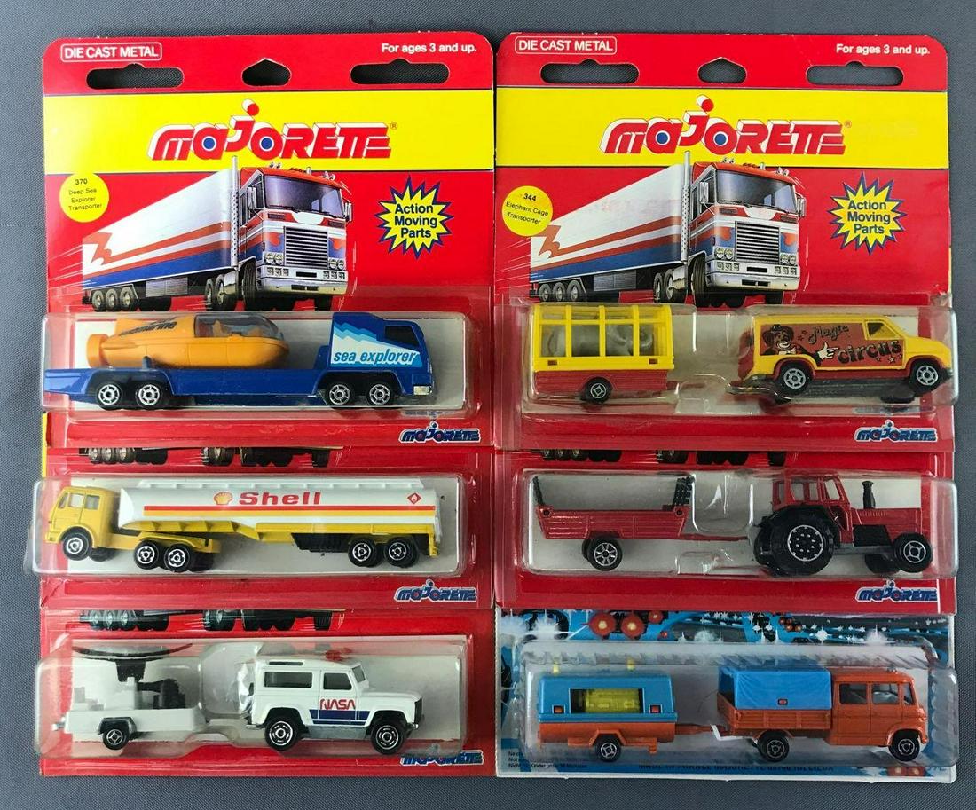 Group of 6 Majorette Die-Cast Vehicles in Original: Includes No. 370 Deep Sea Explorer Transporter, No. 364 Semi-Oil Tanker, No. 369 Tractor and Hay Trailer, and more. Some damage to packaging