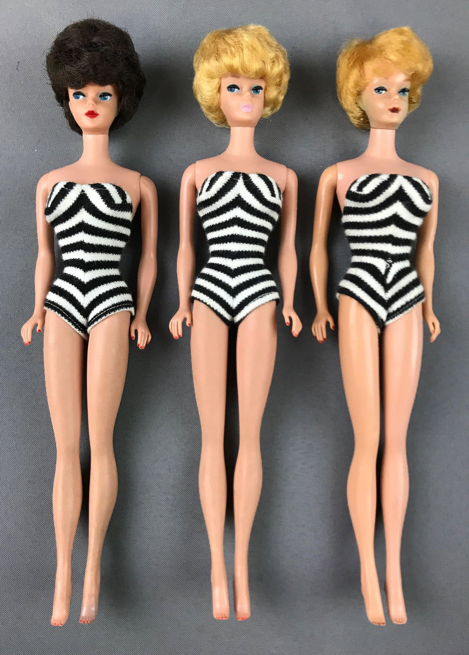 Group of 3 : Vintage Bubblecut Barbies in Black and: One has loose arms and staining. BrunetteÊBarbie has some typical vintage staining consistent with (removed) earringsÊ