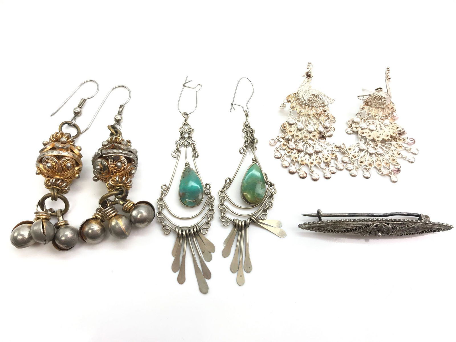 Vintage Filigree Earring Pairs and Bar Pin: Lot features two pairs of delicate chandelier earrings, a bold pair a filigree dangles with a 2 3/4 inch drop and a 1/4 x 2 inch silver filigree bar pin that secures with an open C-clasp
