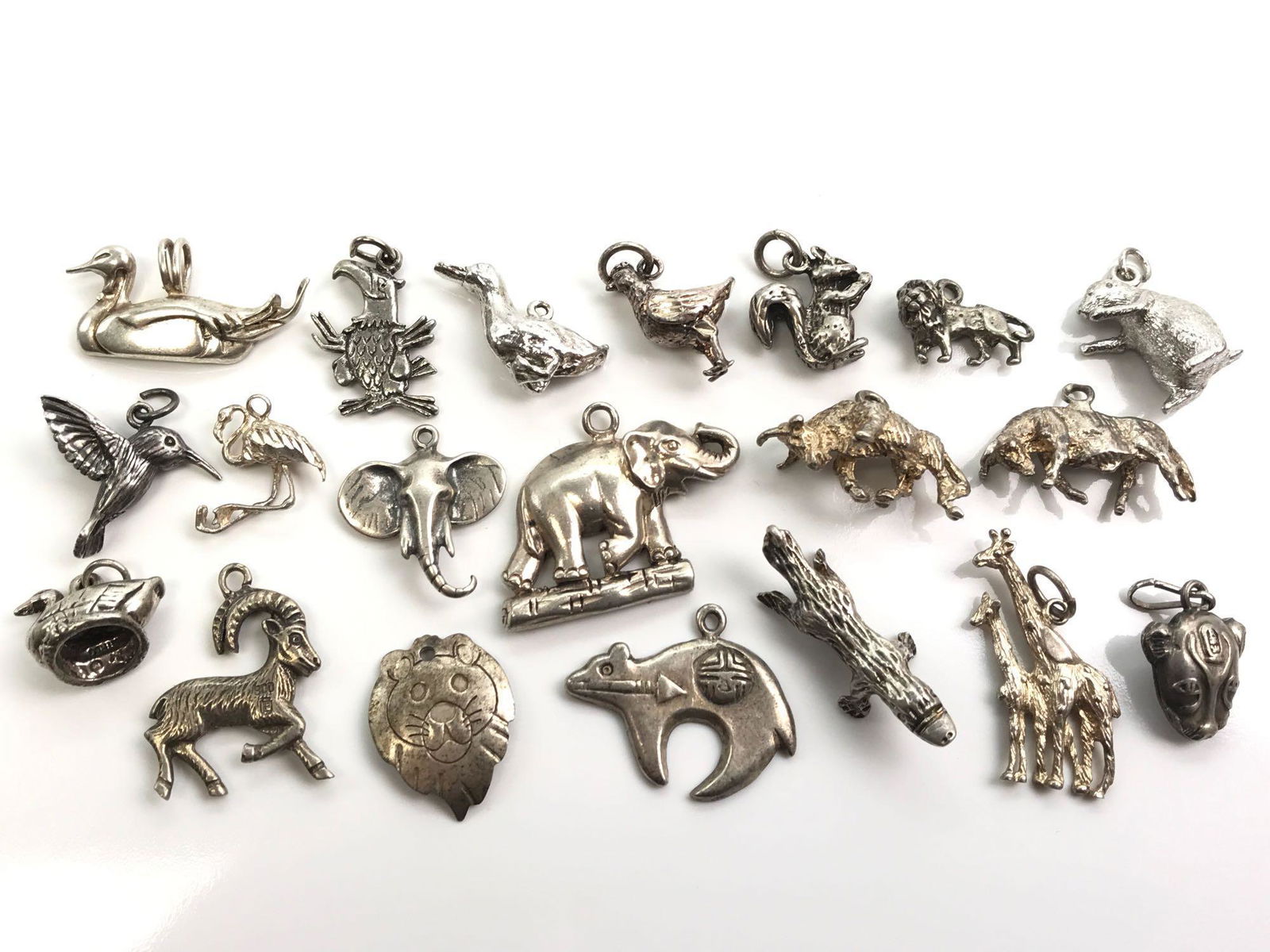 Collection of 20 : Vintage Sterling Silver Charms -: Collection of 20 : Vintage Sterling Silver Charms - Wild Animals + Birds. The lot includes sterling silver lions, tigers and bears as well as some ducks, a chicken, an eagle, hummingbird and a flaming