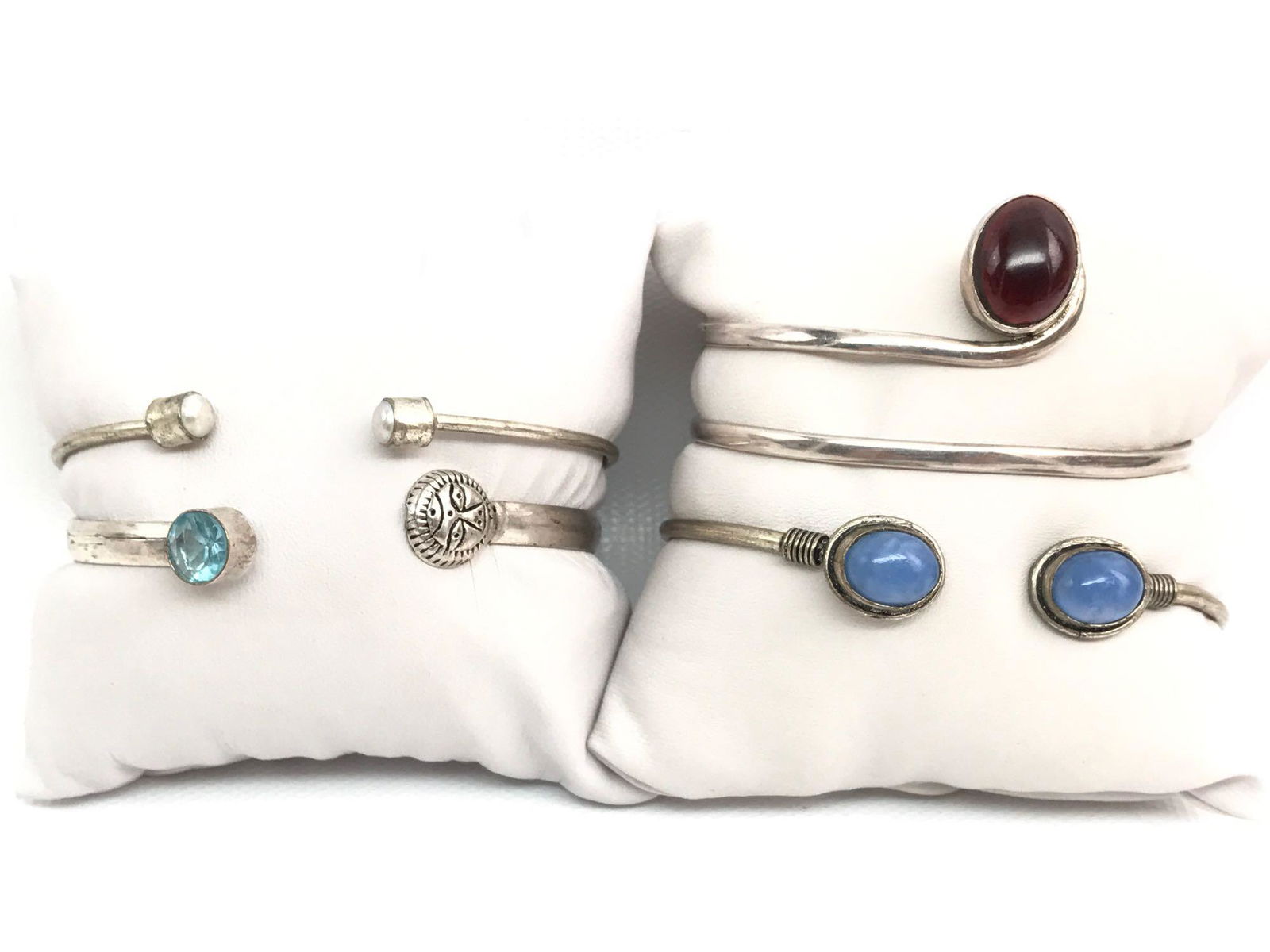 Set of 4 : Sterling Silver Cuff Bracelets - Cabochons +: This lot of sterling silver cuff bracelets features smooth cabochons or faceted finials. The adjustable sterling silver coiled cuff bracelet showcases a pair of subtle violet quartz cabochons. The inn