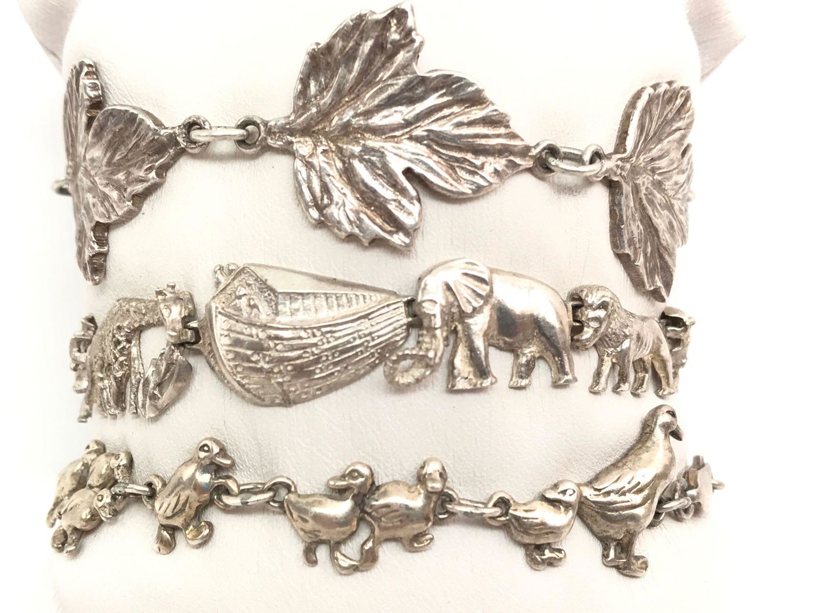 Lot of 3 : Vintage Sterling Silver Link Bracelets -: The lot contains three vintage 7 inch sterling silver bracelets features "ducks on parade", Noah's Ark, and "leaf" links. Each of the bracelets secure with a lobster clasp and have a combined weight o