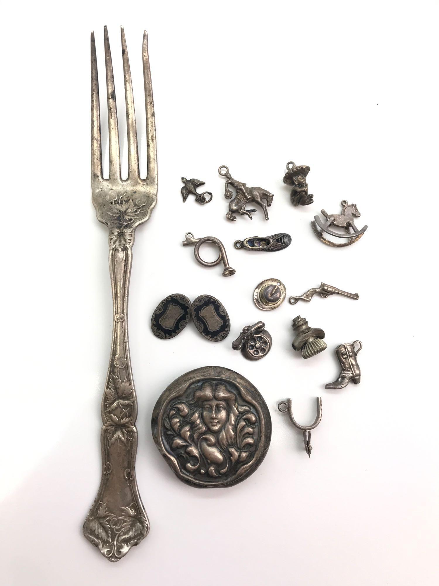 Sterling Silver Assortment - Charms, Fork, and More: This lot consists of sterling charms, a sterling silver dinner fork and more. Total weight for this lot is 66.9g