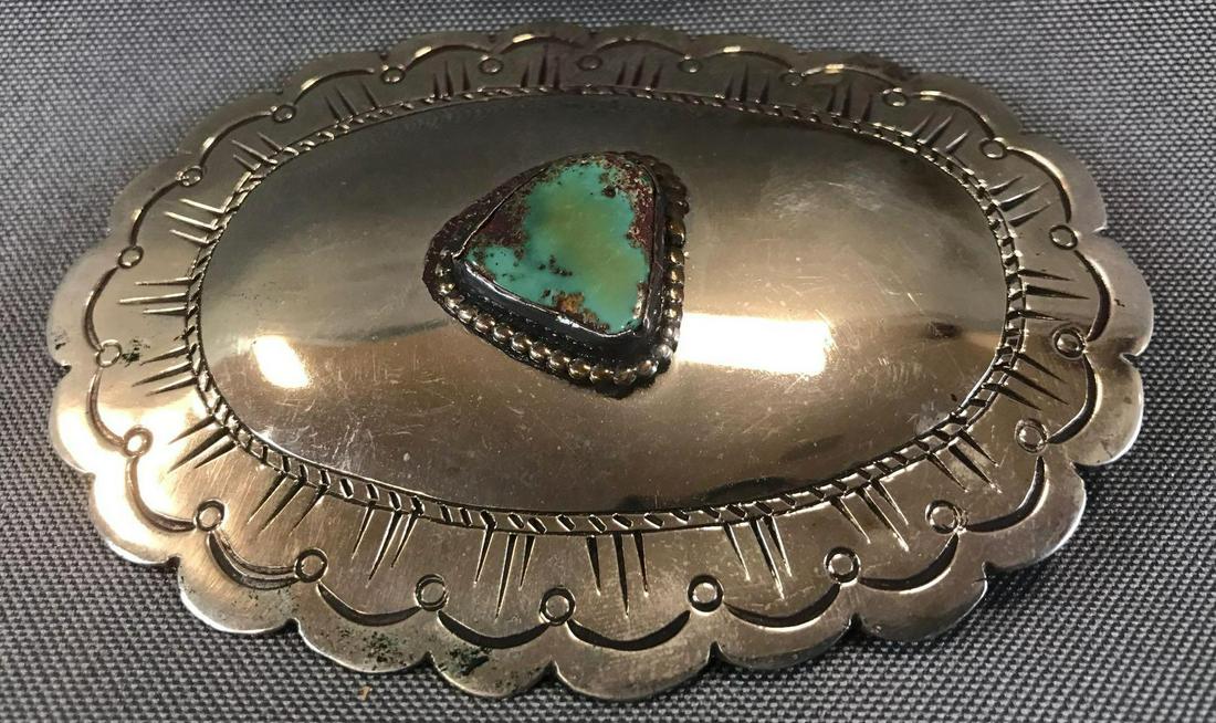 Vintage Silver and Green Turquoise Belt Buckle: Attractively engraved 4 1/4 x 2 3/4 inch silver belt buckle with a bezel set green turquoise center stone; unmarked