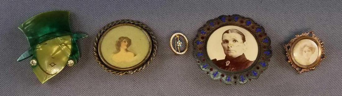 Group of 5: Vintage/Antique Pins: Largest pin in this lot has a 1 3/4 inch diameter. Collection includes fourpins featuring women and one tiny doll pin