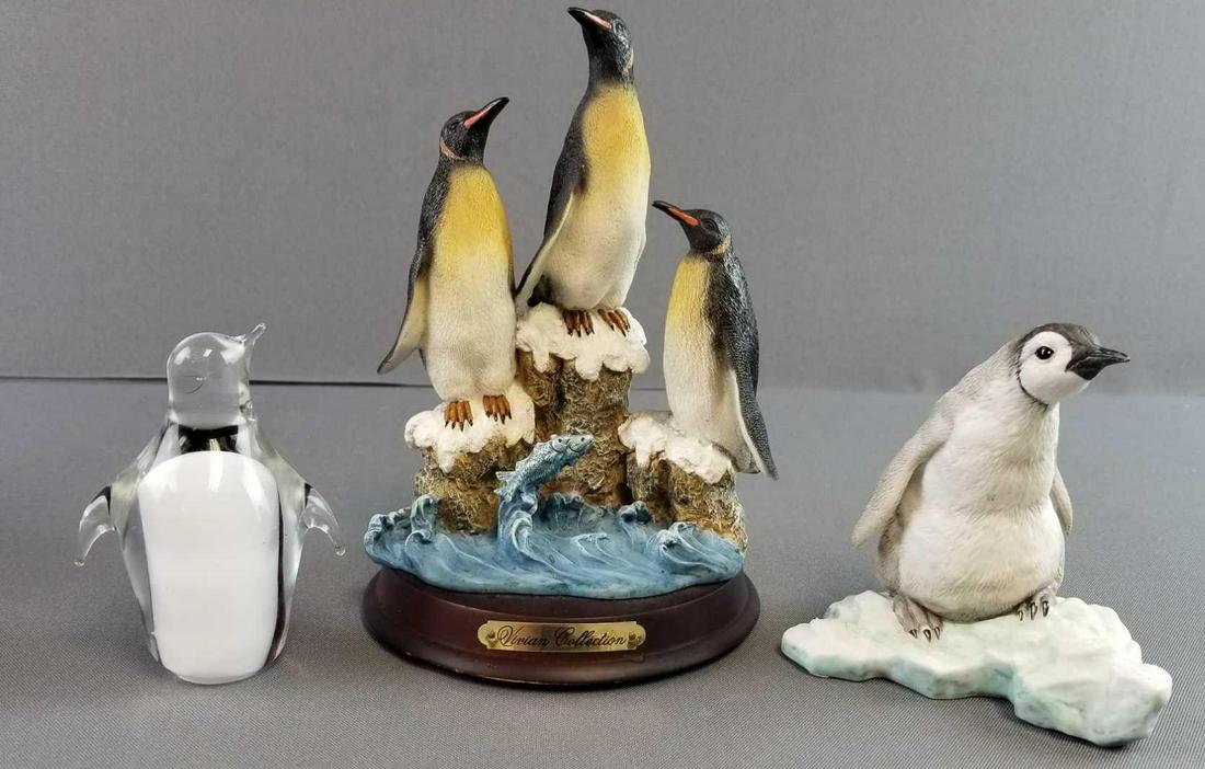 Group of 3: Penguin Figurines: One glass. Tallest is 7 1/2 inches