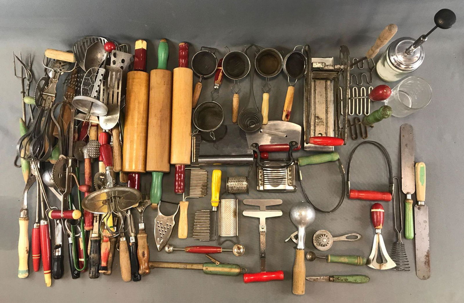 Group of Vintage Kitchen Utensils: Rolling pins, spatulas, slotted spoons, hand mixers, and more.Largest is approximately 17 1/4 inches