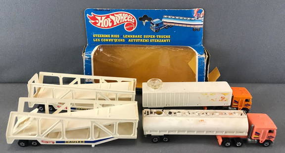 Group of 5 Hot Wheels Trailers, Steering Rigs, and more: Steering Rigs empty box-damaged, car hauler trailers-(1) damaged, Tanker Steering Rig-damaged