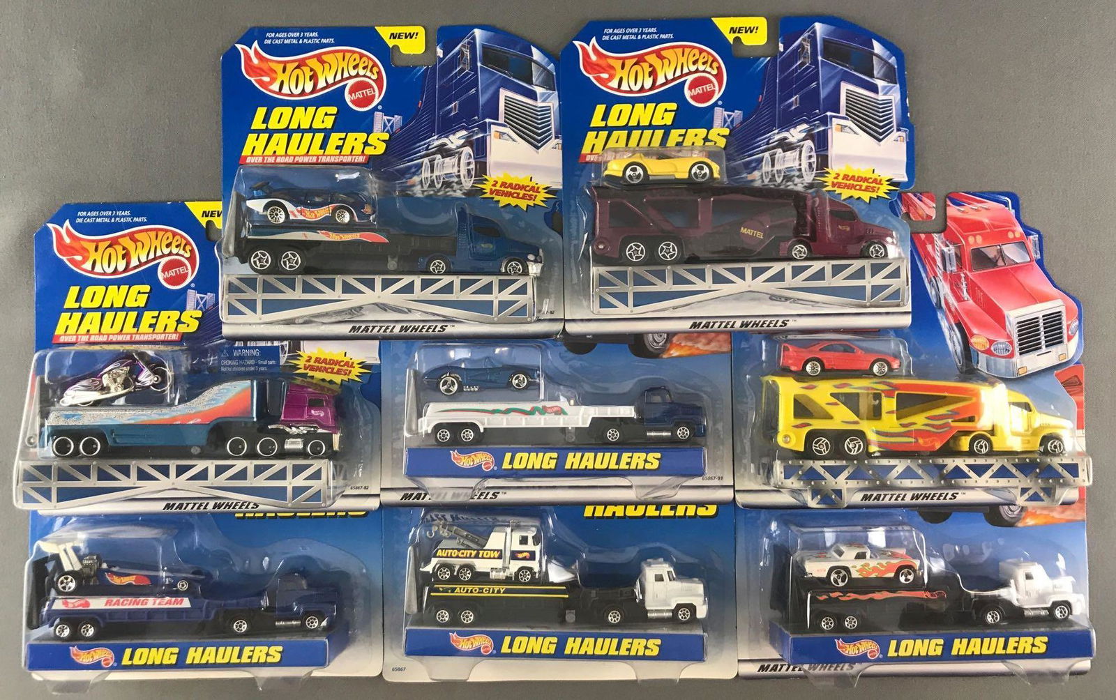 Group of 8 Hot Wheels Long Haulers die-cast vehicle: New in original packaging. Some shelf wear, minor damage to packaging