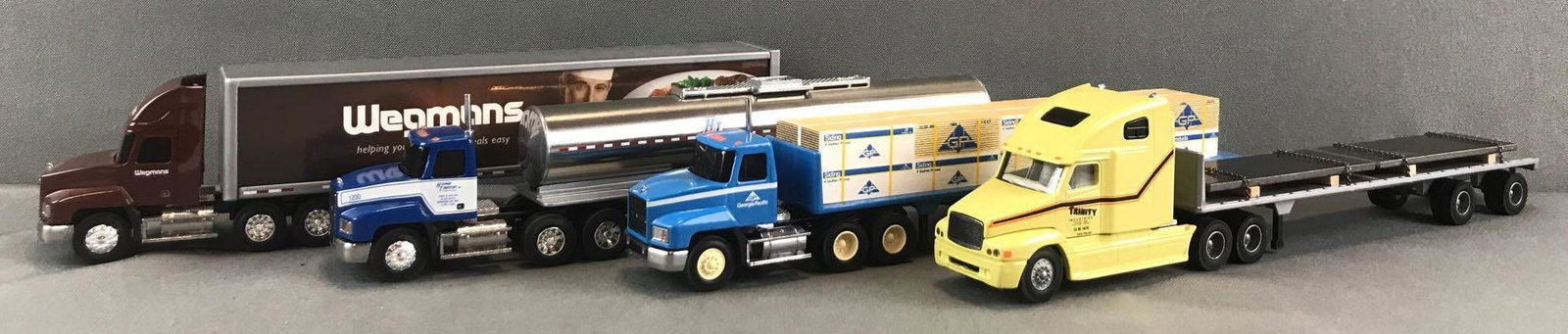 Group of 4 Penjoy die-cast Tractor-Trailers: 1:64 scale. Wegmans, Highway Transport, Georgia-Pacific, and Trinity Industries