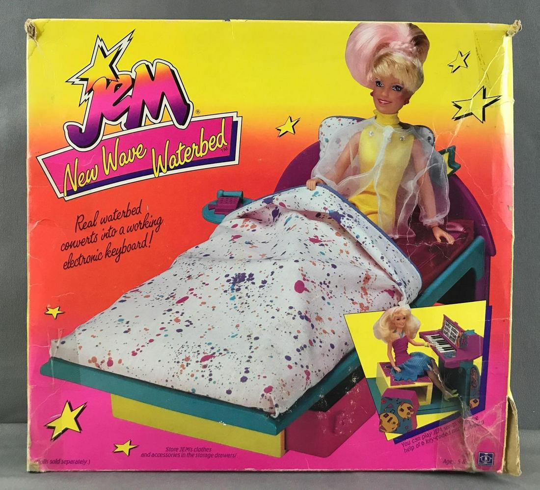 Hasbro Jem and the Holograms New Wave Waterbed in: Packaging measures 15x4.5x14 inches, is open and damaged. Contents appear complete. Untested, used condition