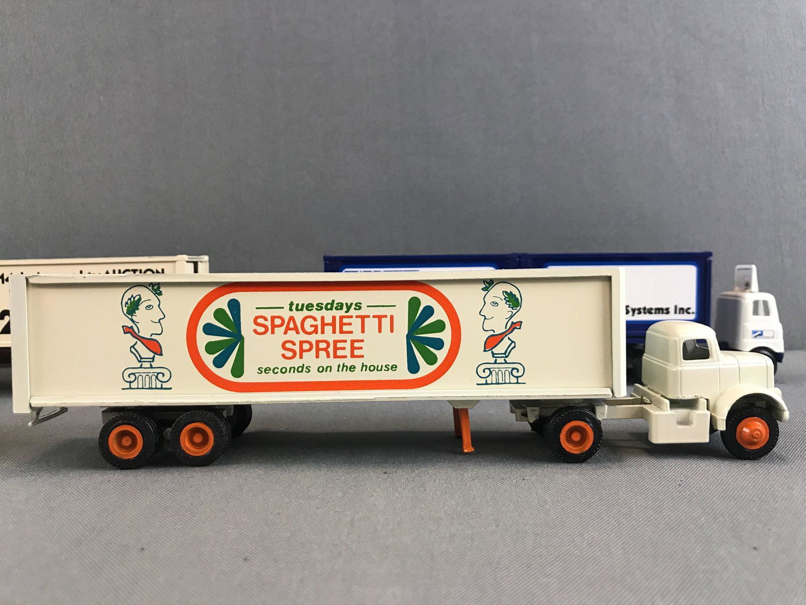 Group of 5 assorted Winross die-cast Tractor-Trailers: 1:64 scale, Howard Johnson, Carrier Systems Inc., 14th Annual TV Auction 1982, and Winross Containers introduced 1981