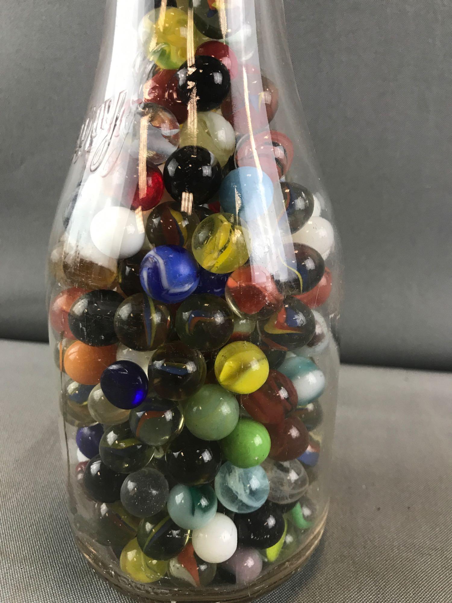 Marbles-Quart size Ideal Dairy Co. glass milk bottle: Bottle is appx 4x9.5 inches. Assorted colors, sizes, and types.