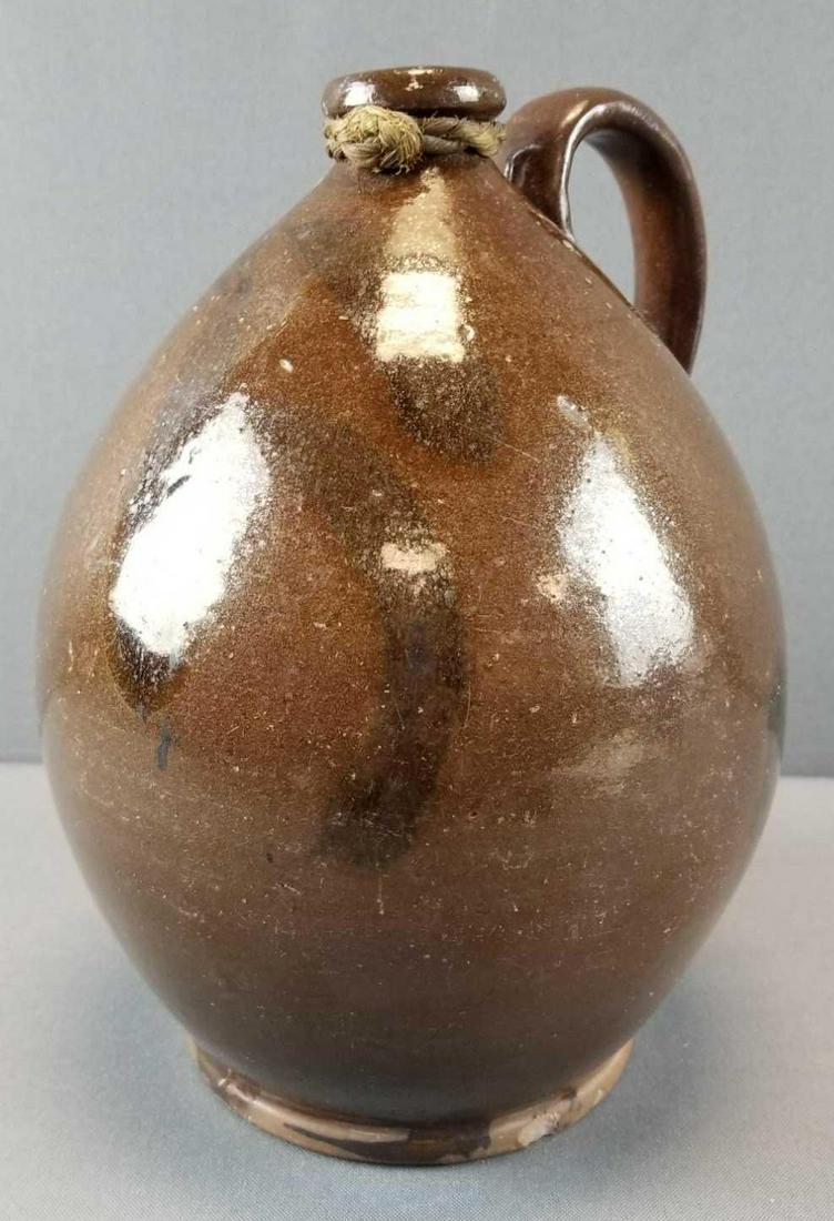 Antique Redware Ovoid Jug: 10 1/2 inches tall. Some chips and wear consistent with age