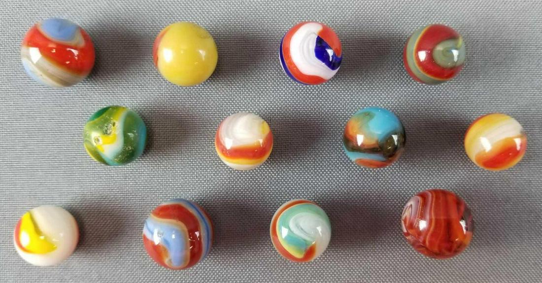 Group of 12 Vintage Glass Marbles Peltier / Akro: Various sizes and styles. One Peltier Comic Marble - Emma, Peltier, Akro, Popeye Corkscrew andmore.
