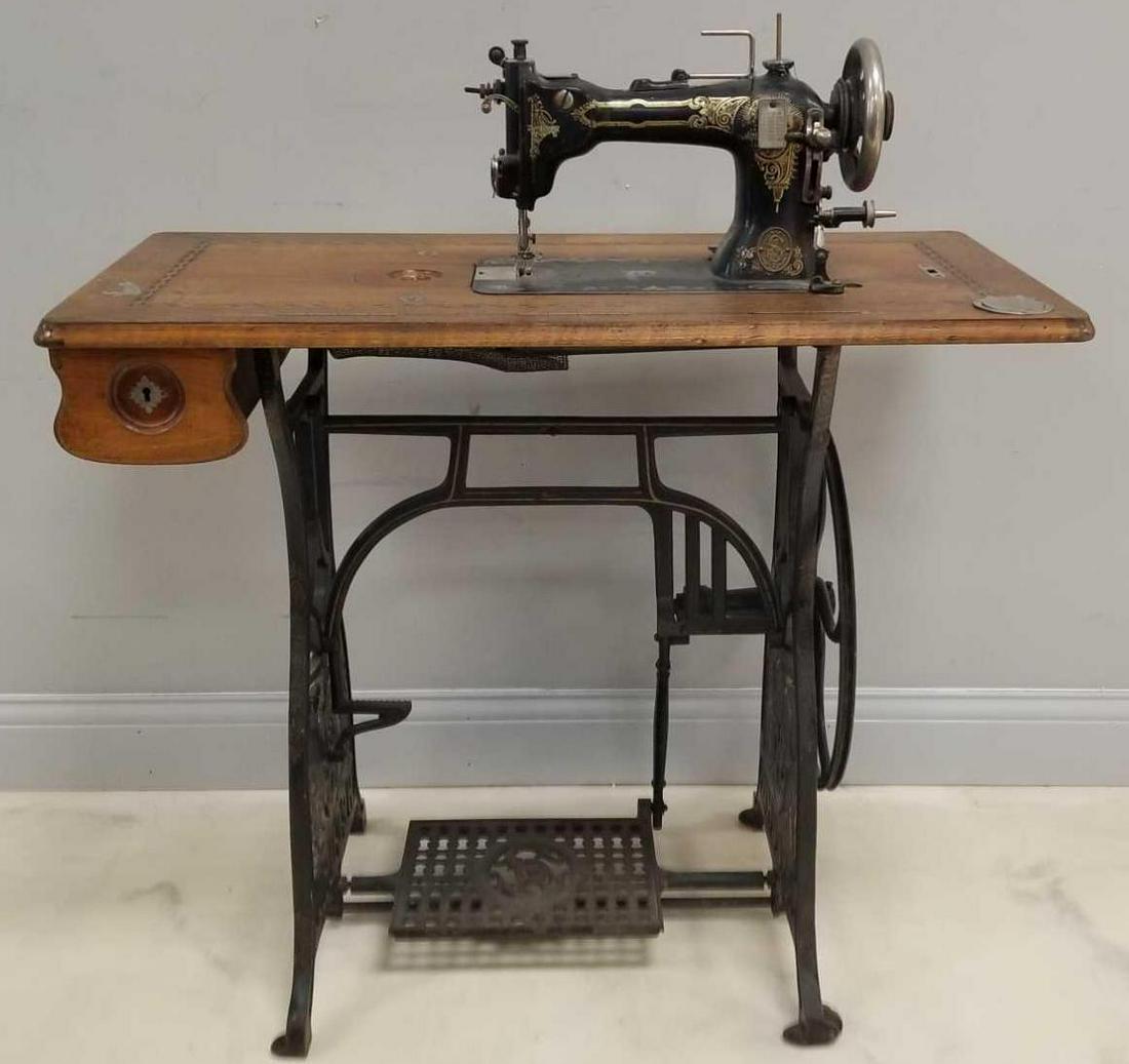 Antique Pedal Sewing Machine: 35 x 17 1/2 inches. Iron base, pedal and wheel. Pedal and wheel work; but needle does not move.In-house shipping is not available for this lot; arrange third party shipping or pick up at our Gallery i