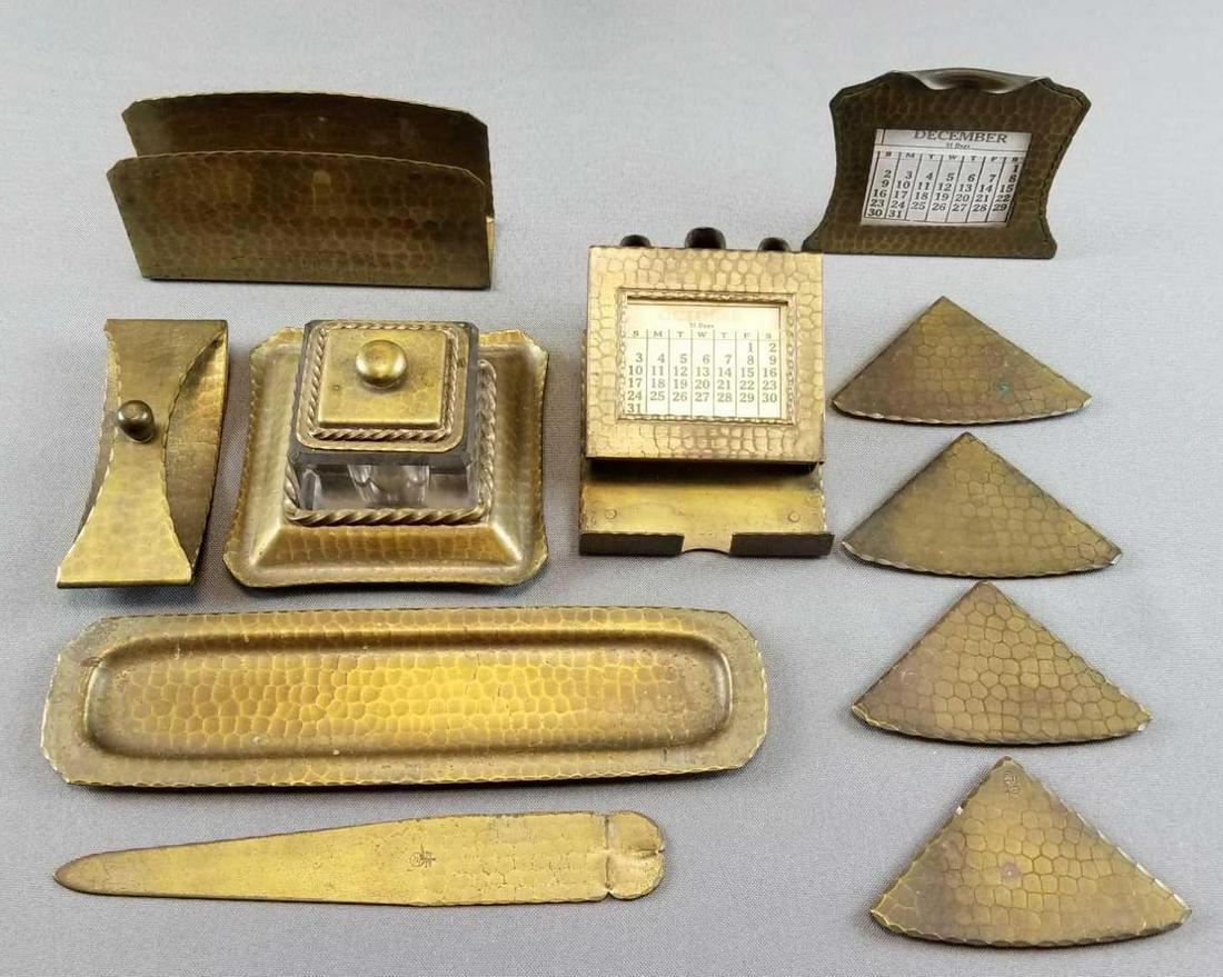 11 Piece Roycroft Arts and Crafts Desk Set: The Roycroft Arts and Crafts desk set contains four blotter corners; calendar, letter opener, inkwell, blotter, pen holder/calendar, letter holder and oval pen tray