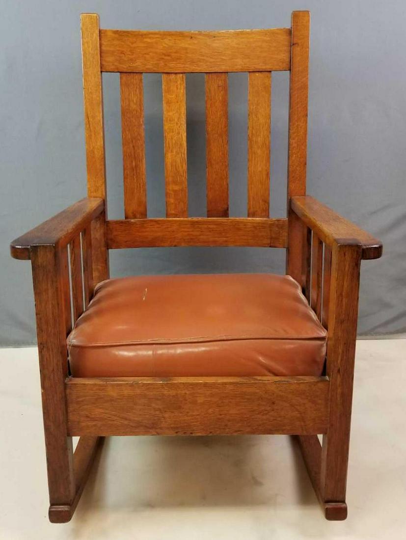 Vintage "Quaint Furniture" Stickley Brothers Rocking: 26 1/2 x 39 inches. Tear in seat, minor wear and scratches consistent with age.In-house shipping is not available for this lot; arrange third party shipping or pick up at our Gallery in Ottawa