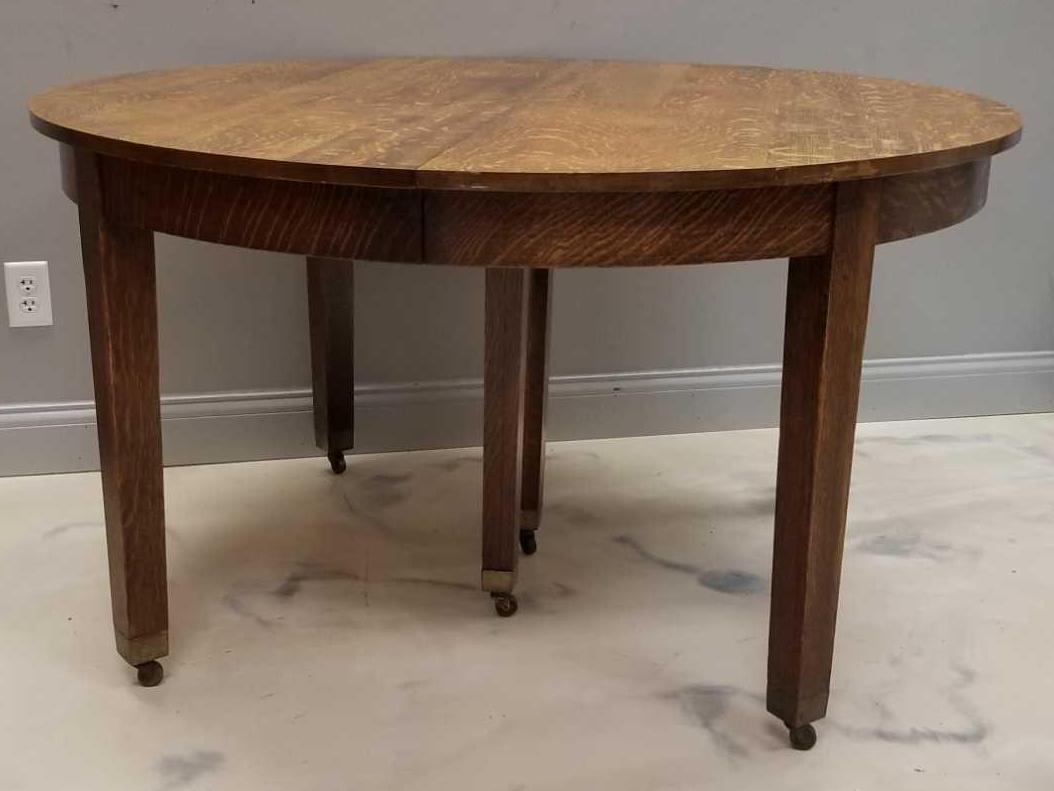 Large Vintage Craftsman Style Dining Room Table: Includes 6 leaves. Without leaves, table measures 54 inch diameter. Table is on casters. Minor wear consistent with age. In-house shipping is not available for this lot; arrange third party shipping o