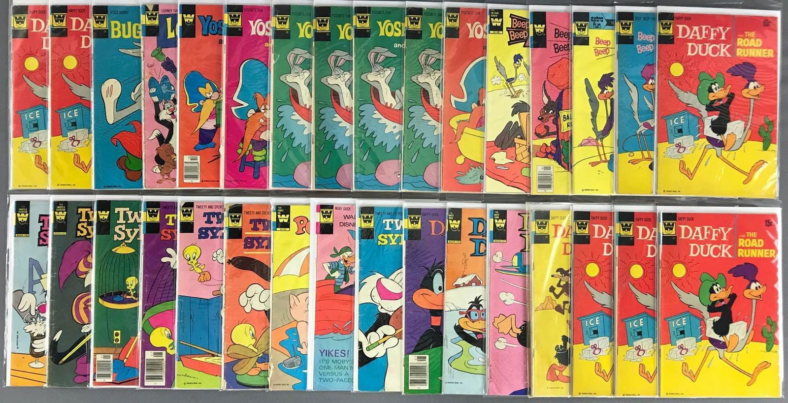 Group of 30 Plus Whitman Assorted Walt Disney Comic: Includes Daffy Duck and The Road Runner, Daffy Duck, Tweety and Sylvester, Moby Duck, Porky Pig, Road Runner, Yosemite Sam and Bugs Bunny, Looney Tunes & Bugs Bunny. Bagged and boarded, includes dupli