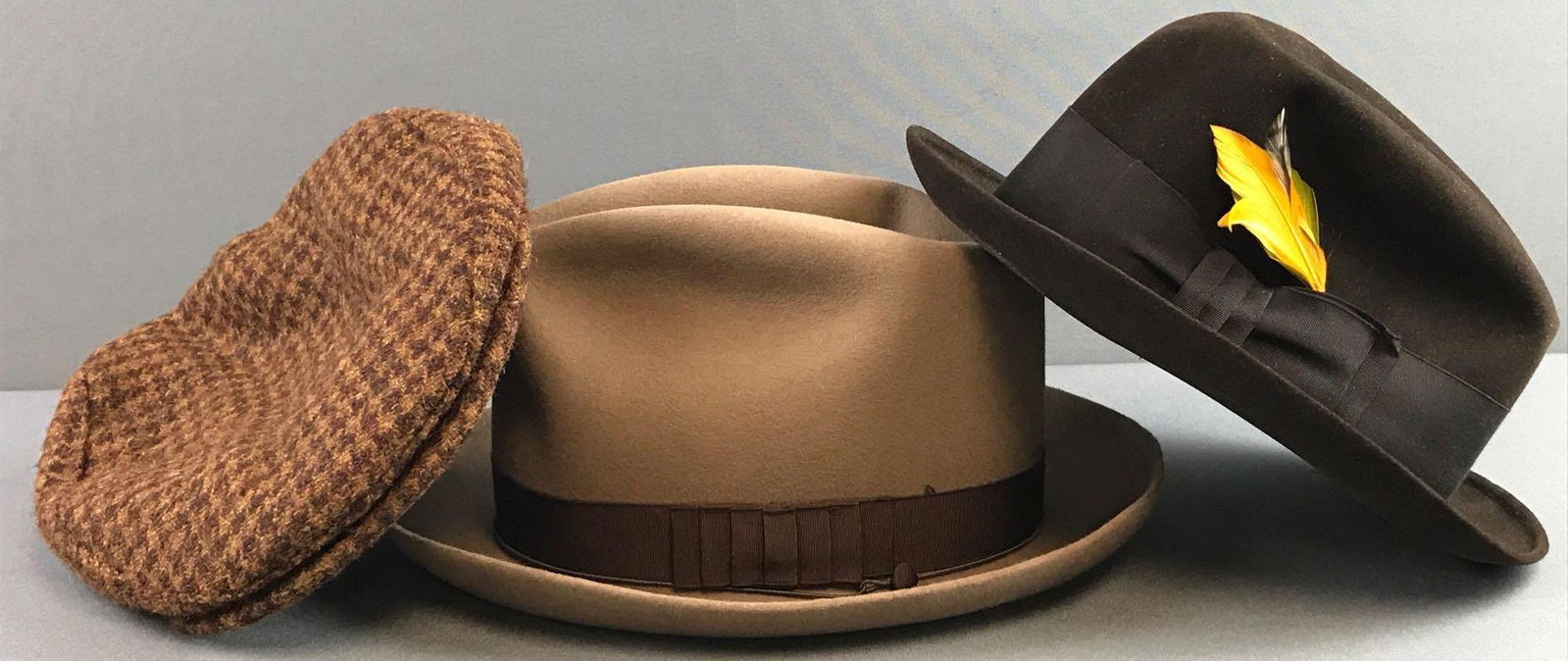 Group of 3 Vintage Hats: Includes mens fedora, dress hat & flat cap. Includes hats by Harris Tweed, Borsalino, and Donna. Largest measures 5.25x12.25x10.5 inches. The brown hat is 7 1/8, the black hat is 6 7/8, and the Hounds