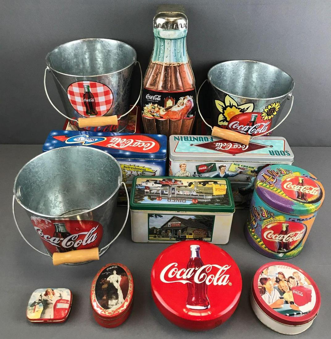 Group of 14 Coca-Cola tins and metal buckets: Assorted sizes and shapes. Largest is 13 inches