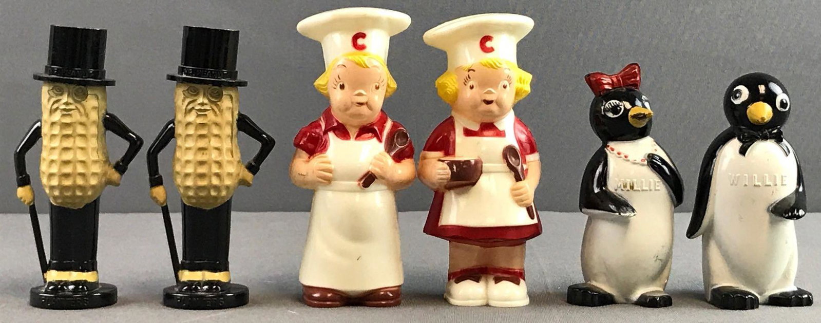 Group of 3 Vintage Salt Shakers: Plastic and includes Planters Peanuts, Campbell Soup, and F and F Mold and Die Works Willie and Millie. Largest measures 4.25x1.75x1.5 inches.