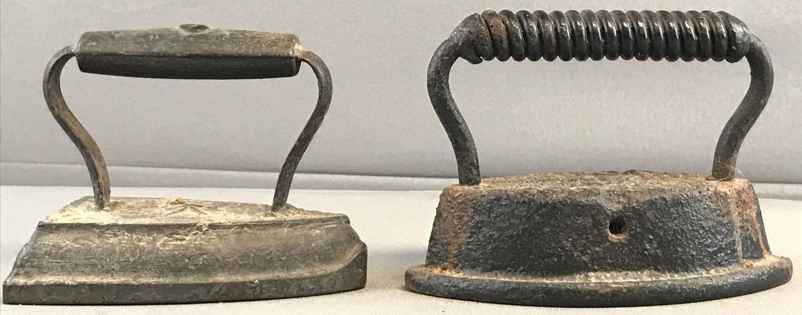 Group of 2 Iron Presses: Largest measures 7x5x3.5 inches.