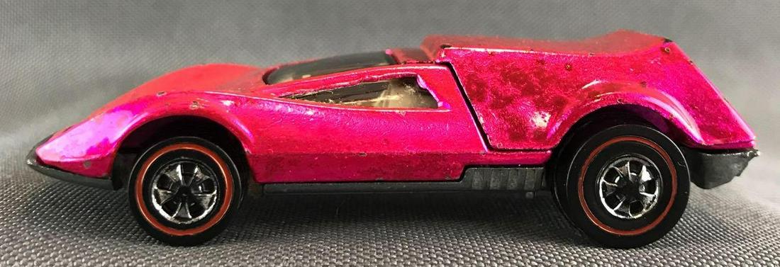 Hot Wheels Redline Tri-Baby die-cast vehicle: 1969 Mattel, Inc. Hot Pink Body Color. Near Mint to Excellent Condition with some noticeable wear on edges nad wheels. Tan interior