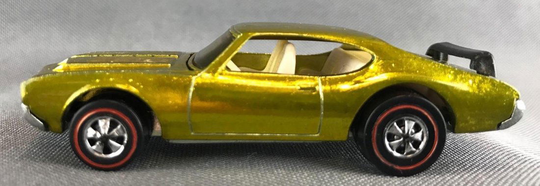 Hot Wheels Redline Olds 442 die-cast vehicle: Rare Original Black Plastic Wing, 1969 Mattel, Inc. Yellow/Lime Body Color. Mint Condition. The car appears mint at first glance. Upon close inspection shows slight imperfections, very minor toning do