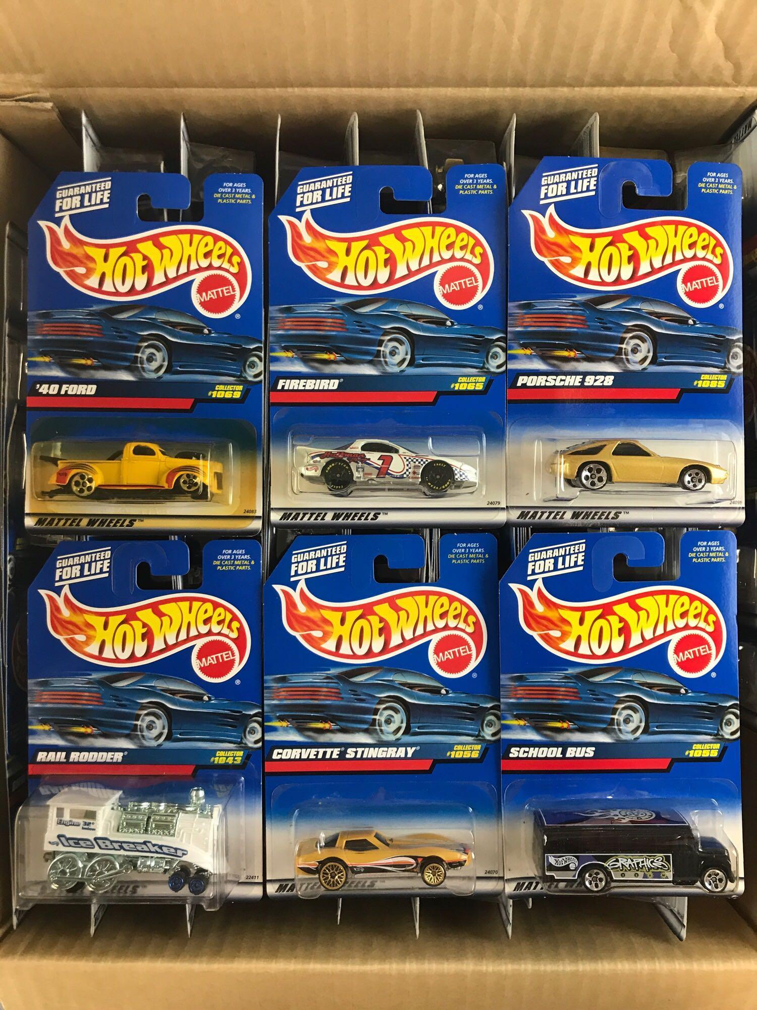 Full shipping box of assorted Hot Wheels die-cast: 70+ pieces, includes Firebird, Porsche 928, Rail Rodder, and more.