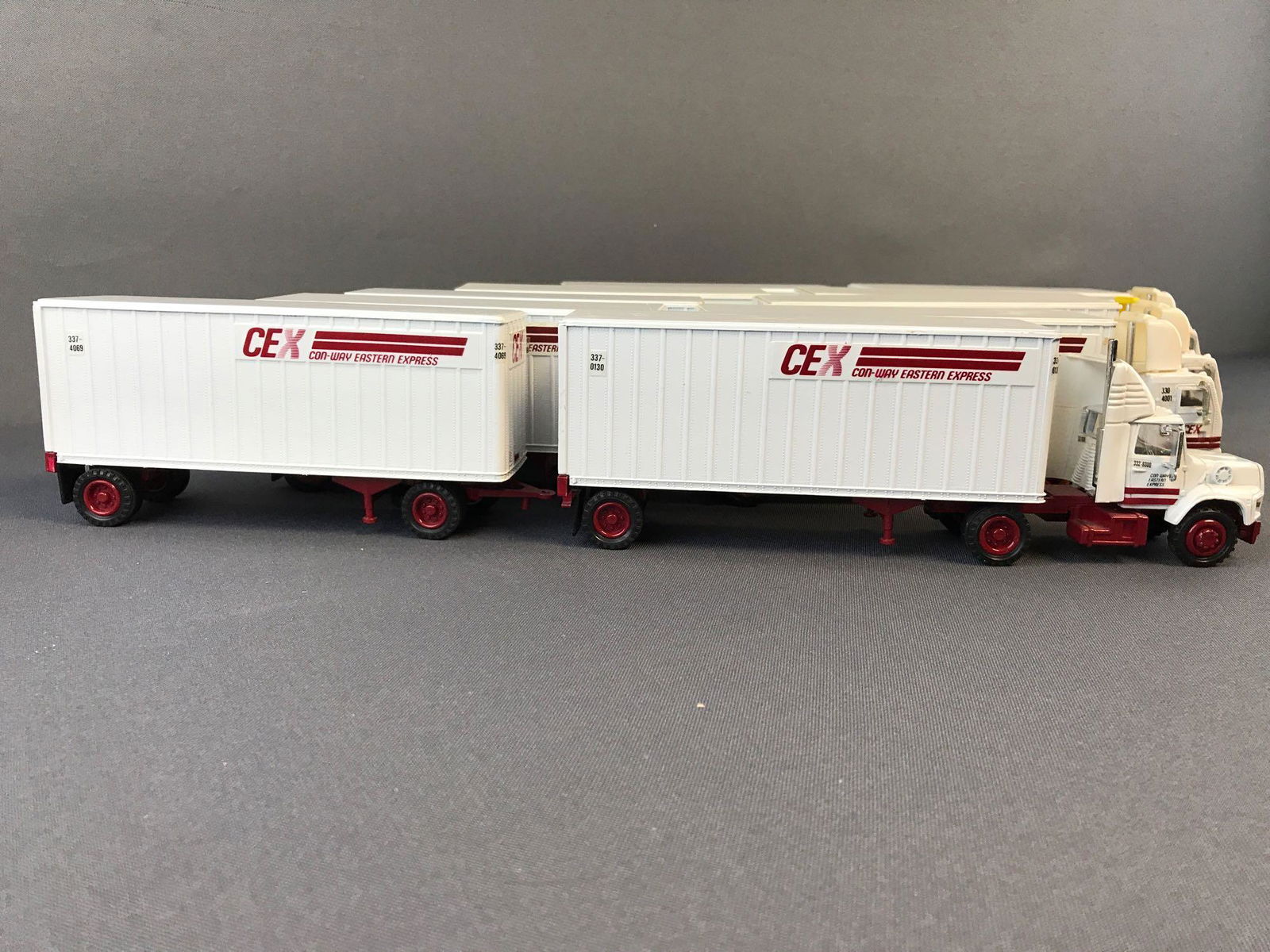 Group of 5 Tonkin Replicas die-cast tractor double: Measures 15.25x3x2 inches. Includes three CEX, one with glue resin on all tires, CCC with glue resin on all tires and Viking Freight System. Wear consistent with age.