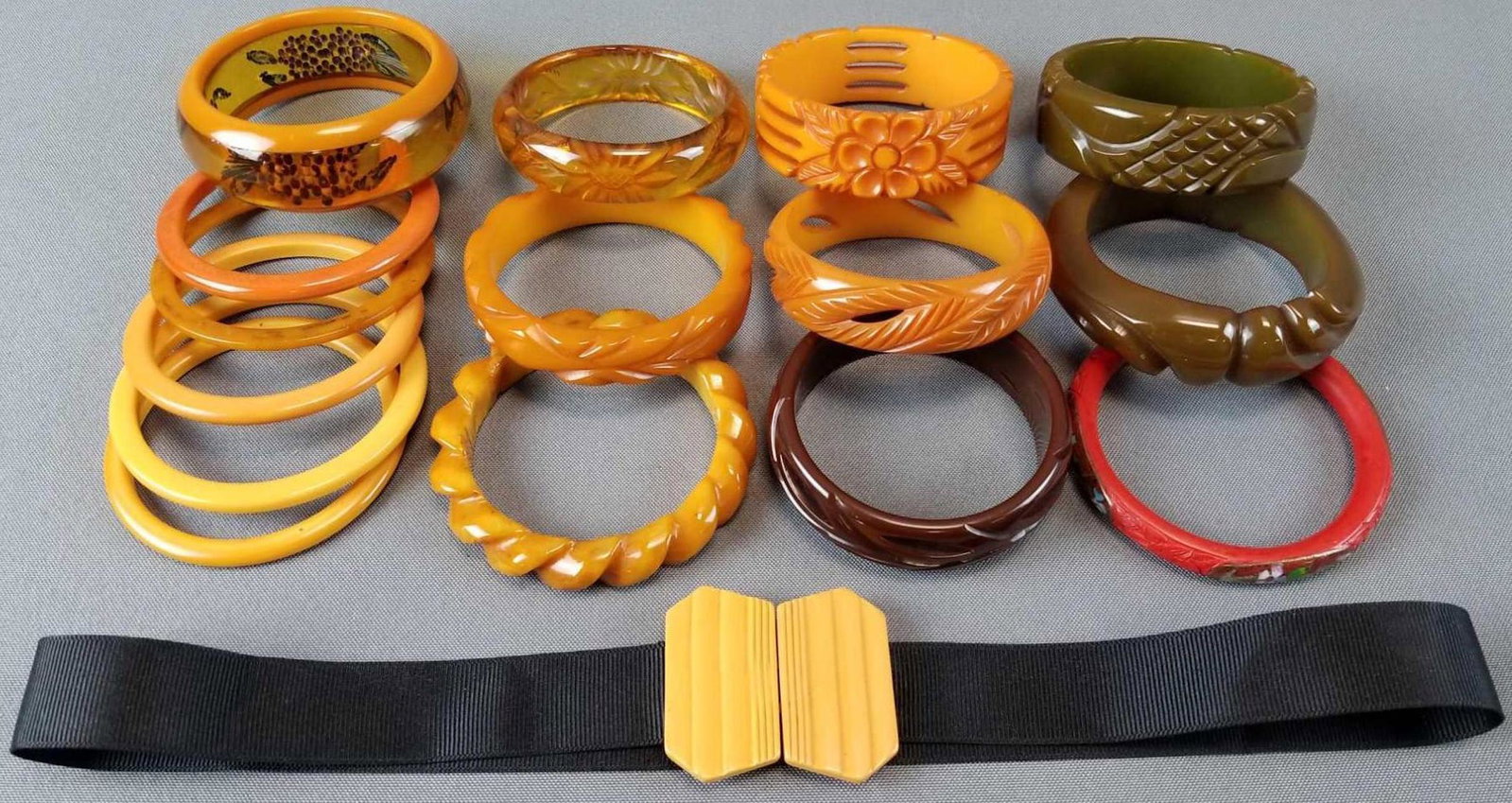Group of vintage bakelite and lucite bangle bracelets: Also includes ribbon belt with bakelite clasp. 15 bracelets