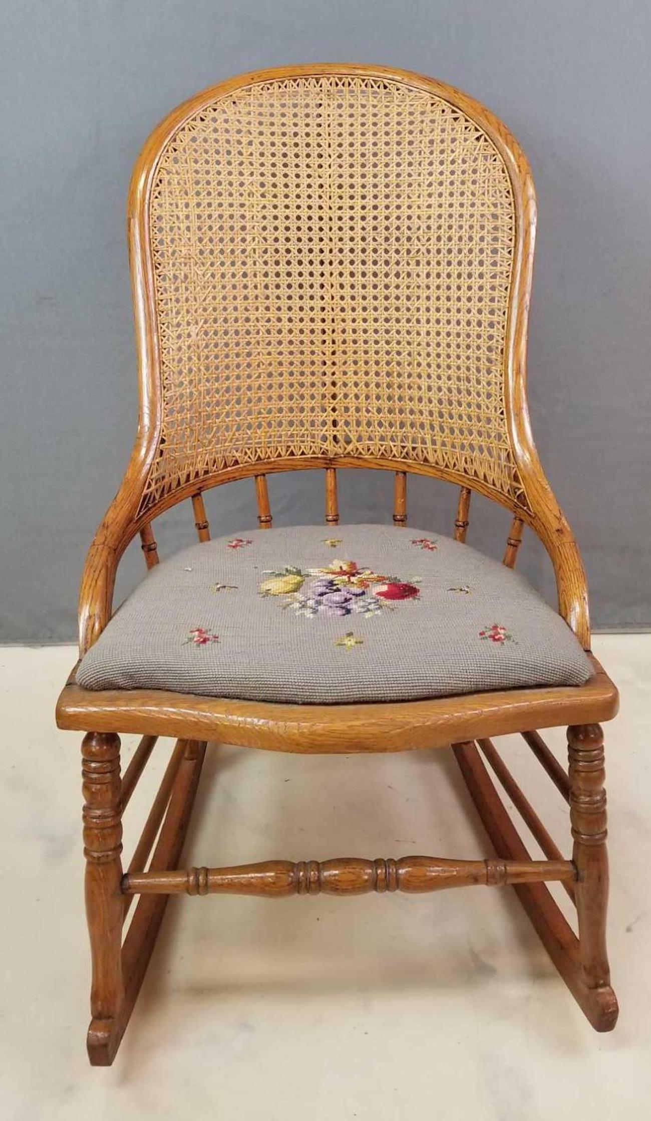 Vintage Rocking Chair with Needlepoint Seat: 19 x 33 inches. In-house shipping is not available for this lot; arrange third party shipping or pick up at our Gallery in Ottawa