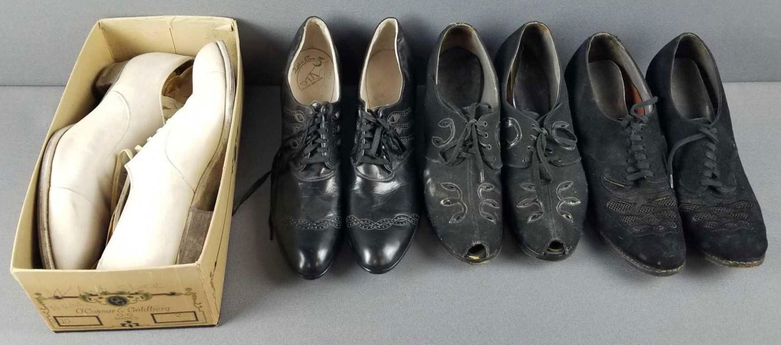 4 pair of vintage shoes: Mens white shoes, 4 pair of womens black shoes. All show wear from age and use