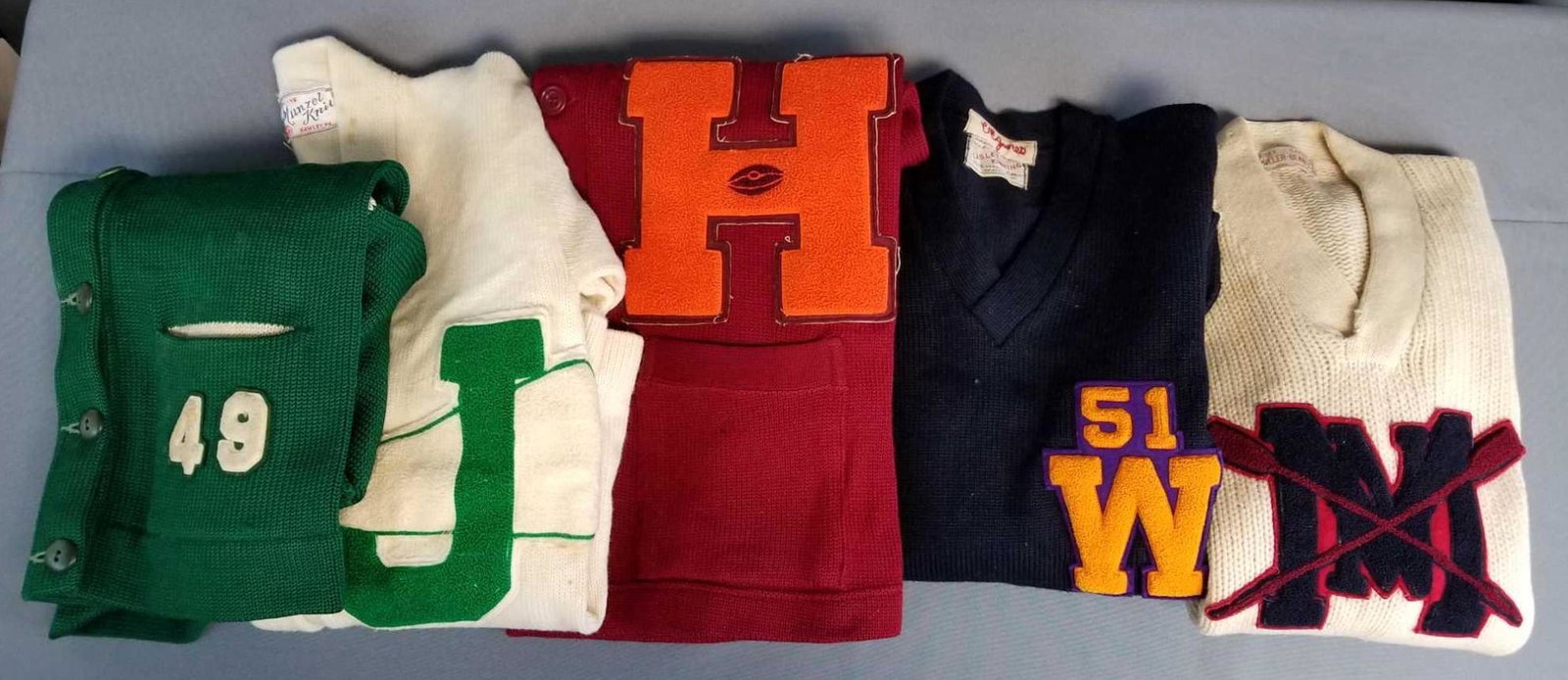 Group of 5 vintage letterman varsity sweaters: Green, red, navy, cream. Pullovers and cardigans. All have stains, wear, or holes