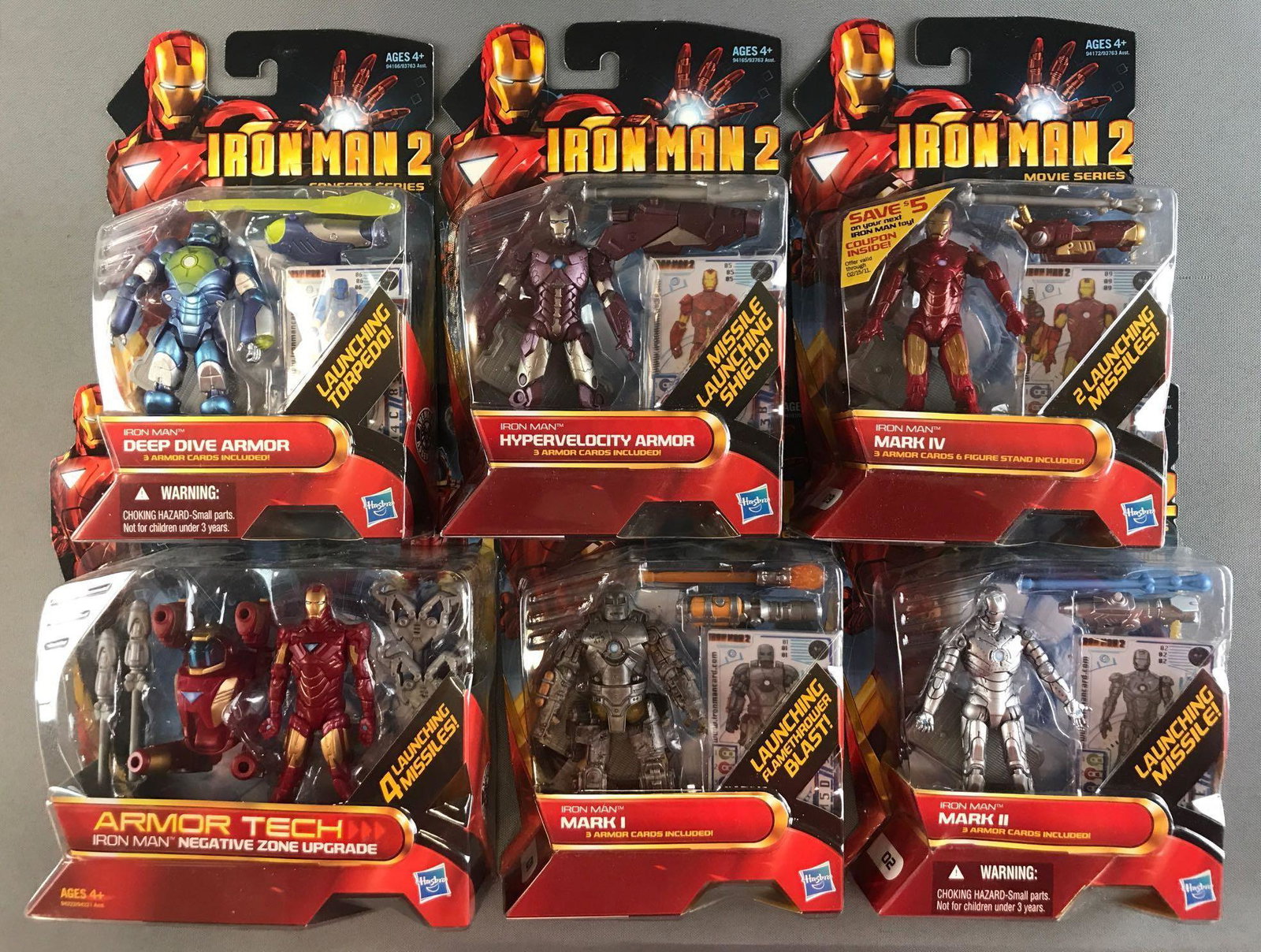 Group of 6 Hasbro Iron Man 2 action figures in original: Includes Mark I, Armor Tech Negative Zone Upgrade, Hypervelocity Armor, and more. Figures are appx 3.75 inches. Largest package measures 6.5x8.25x1.5 inches