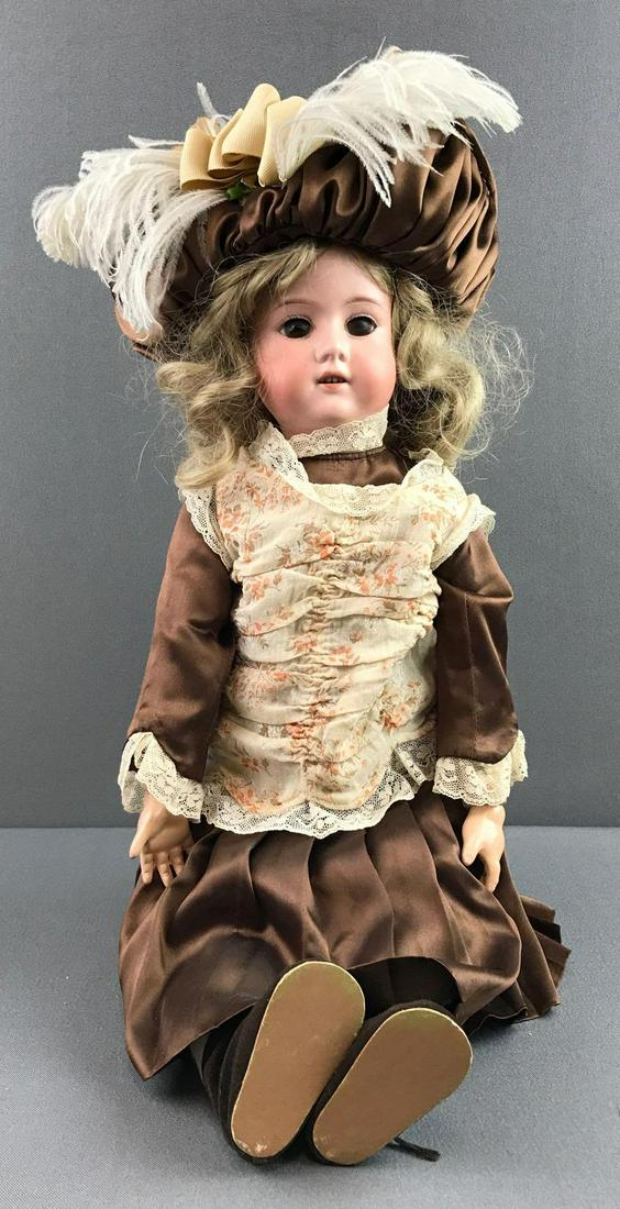 Antique 18 inch German bisque doll Marseille: Socket head, Armand Marseille 390, stationary glass brown eyes with painted lashes, open mouth with teeth, composition and wood jointed body. Brown satin dress, under garments, socks and shoes.